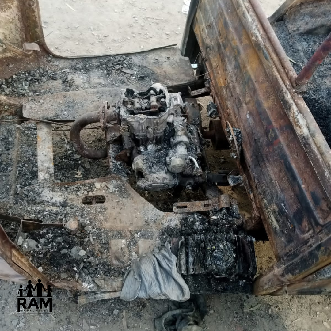 Rickshaw 2 - WITH LOGO The burnt engine remains of a rickshaw are charred and ashy gray.